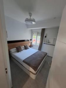 a bedroom with a large white bed in a room at H Bella Mar Roses in Roses +57 photos