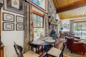 a dining room with a table and chairs at Treetop Cottage in Running Springs