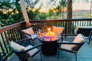 a table with a fire on it on a deck at Lakeside Serenity in Crestline
