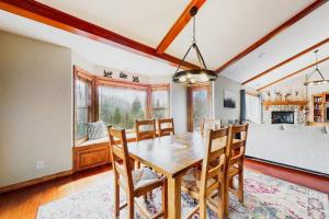 a dining room with a wooden table and chairs at Deer Mountain in Lake Arrowhead +21 photos