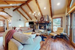 a living room with a couch and a fireplace at Arrowhead Haven in Lake Arrowhead
