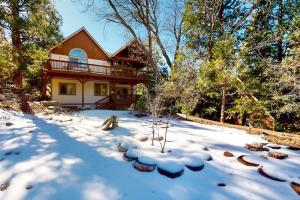 a house in the snow with snow covered yard at Arrowhead Haven in Lake Arrowhead +37 photos