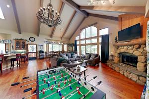 a living room with a pool table and a fireplace at Emerald Oasis in Lake Arrowhead