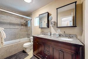 a bathroom with a sink and a toilet and a shower at Treelands Lodge in Crestline