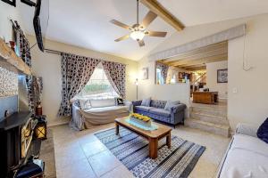 a living room with a couch and a table at Treelands Lodge in Crestline