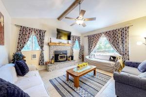 a living room with a couch and a table at Treelands Lodge in Crestline