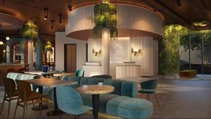 a restaurant with blue chairs and tables and tablesktop at Me and All Hotel Leipzig, by Hyatt in Leipzig +14 photos