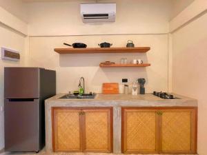 a kitchen with a sink and a refrigerator at Villa Xana - Private pool - SOFT OPENING in General Luna
