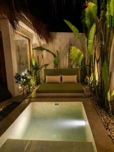 a pool in the middle of a room with plants at Villa Xana - Private pool - SOFT OPENING in General Luna