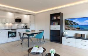 a kitchen and dining room with a table and chairs at Princess in Binz