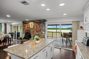 a kitchen and living room with a stone fireplace at Waterfront Gem in Willingboro