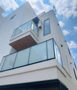 a building with glass windows on the side of it at LIFEMENTGLANZ HOTEL Enomachi in Hiroshima