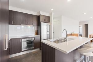 a kitchen with brown cabinets and a white counter top at Marlin Vista - Pet Friendly in Eden