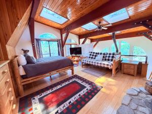 a living room with a bed and a couch at The Valley's Cabin in Green Valley Lake +15 photos