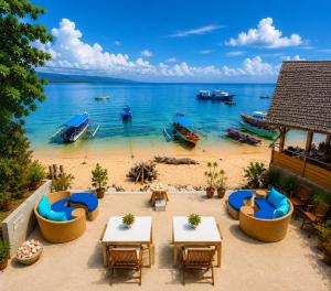 a view of a beach with tables and chairs at Bunaken Paradise Beach Homestay in Bunaken