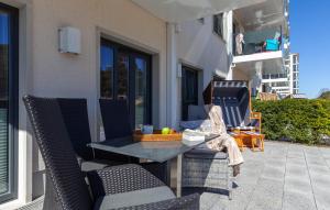 a patio with a table and chairs on a balcony at Moon in Binz +35 photos