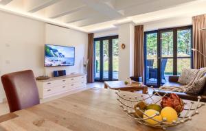 a living room with a bowl of fruit on a table at Moon in Binz
