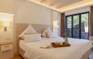 a hotel room with a bed with a tray with books at Moon in Binz