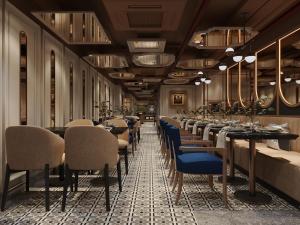a restaurant with a long row of tables and chairs at MAY DE VILLE Prestige Hotel in Hanoi