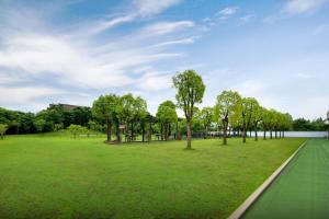 a park with trees and a green field at ShangHai LuAn Garden Hotel-Complimentary shuttle service between Shanghai Pu d ong Airport and Disneyland in Shanghai