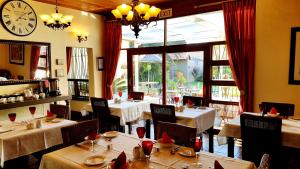 a restaurant with tables and chairs and a clock on the wall at Jubilee Lodge Guest House in Johannesburg