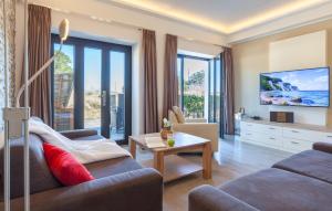 a living room with a couch and a tv at Amber in Binz