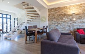 a living room with a table and a staircase at Amber in Binz +42 photos