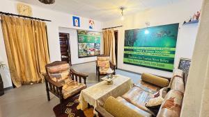 a living room with a couch and chairs at Claasz Prime Lagoon in Katunayaka