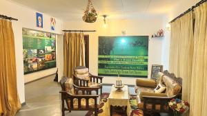 a living room with chairs and a couch and a table at Claasz Prime Lagoon in Katunayaka +44 photos