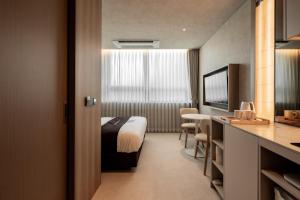 a hotel room with a bed and a table at My Me Hotel in Seoul
