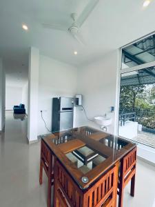 a room with a wooden table and a sink at Celestial Nymph by Natureloom in Vagamon