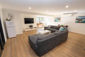 a living room with a couch and a tv at Amity Escape - Sleeps 14 in Amity Point