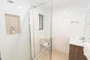 a bathroom with a shower and a toilet and a sink at Amity Escape - Sleeps 14 in Amity Point +26 photos