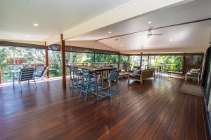 an empty living room with a table and chairs at Amity Escape - Sleeps 14 in Amity Point