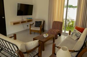 a living room with a couch and chairs and a tv at Don Checho's House in Ica