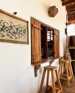 a table and two stools in a room with a window at Kita Ocean House in Kiwengwa +23 photos