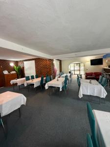 a dining room with white tables and chairs at Zero Inn Motel in Nhill