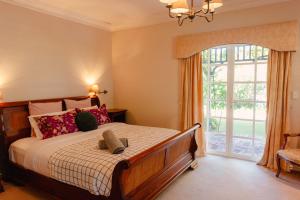 a bedroom with a bed and a large window at Lanterns Retreat in Dunsborough +72 photos