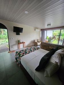 a bedroom with a large bed and a large window at Yellow Tree Suites in Fortuna +87 photos