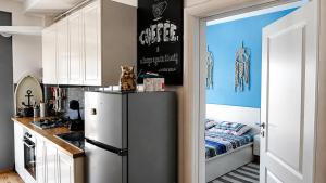 a kitchen with a refrigerator and a cat sitting on top of it at Sea Ray Studio in Năvodari