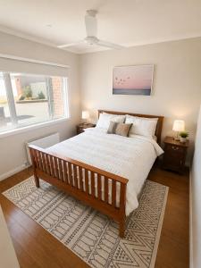 a bedroom with a large bed and a window at Bellarine Breeze in Drysdale