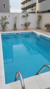 a large blue swimming pool on top of a building at Sea Ray Studio in Năvodari