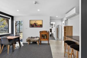 a kitchen and dining room with a table and chairs at Tyrola 11 in Thredbo