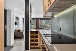 a kitchen with a counter top and some windows at Tyrola 11 in Thredbo