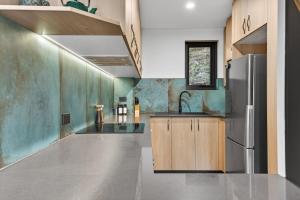 a kitchen with a sink and a refrigerator at Tyrola 11 in Thredbo