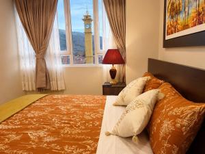 a bedroom with a bed and a window with a clock tower at Chanka Suites in Talavera