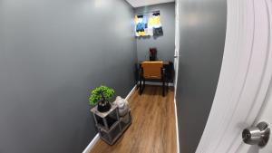 a hallway with a chair and a plant on the floor at Cozy Private Two Bedroom Basement Apartment in Hempstead