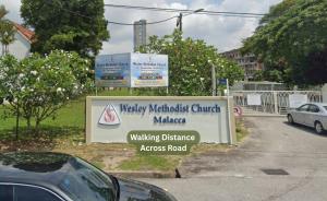 a sign for the wacky methiod church marina walking distance across a road at Swing & Pillows - Klebang, Melaka in Malacca