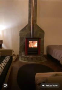 a living room with a fireplace in a room at Casona san isidro in Vicuña