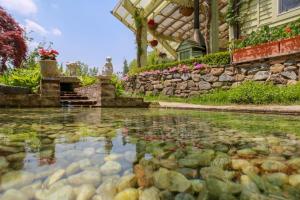 a pool of water in front of a house at Herb Village in Yeoncheon